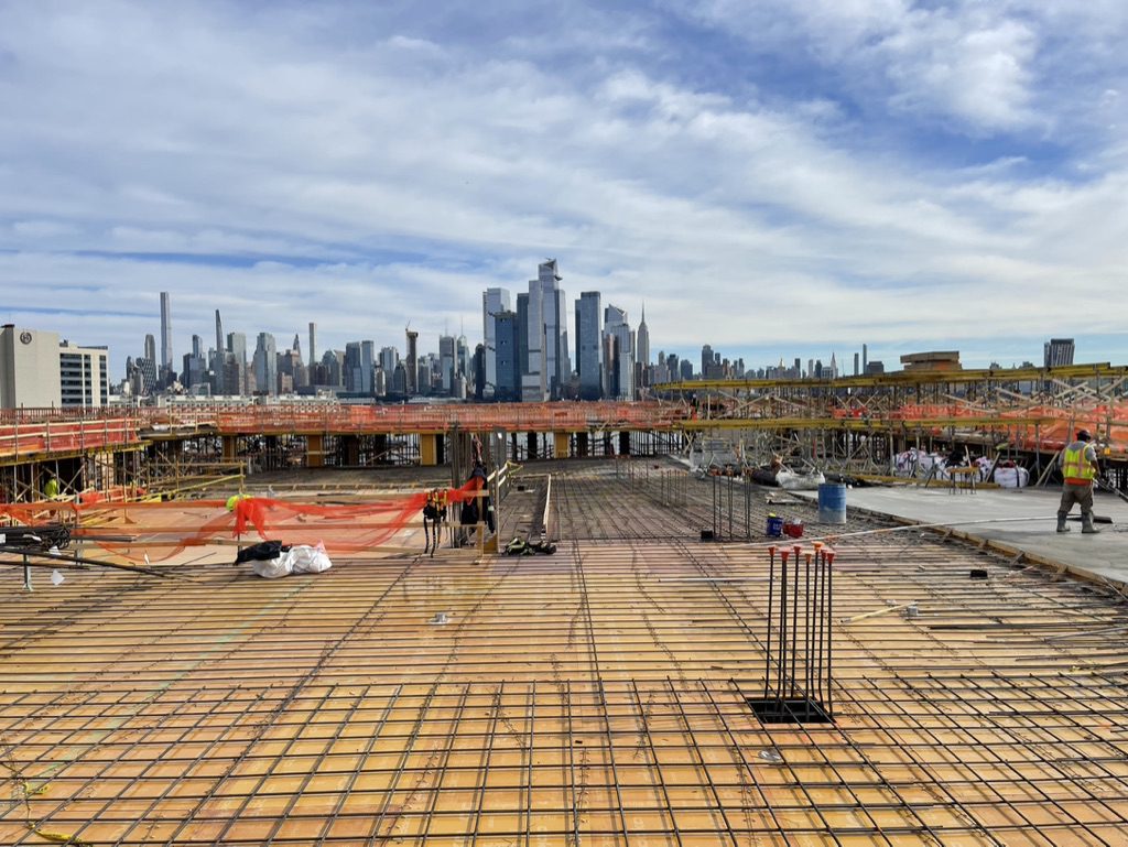  worker tiling floor with material